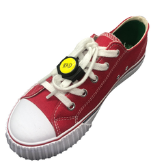 Single red shoe with black knotbots shoelace lock keeping the shoe tied